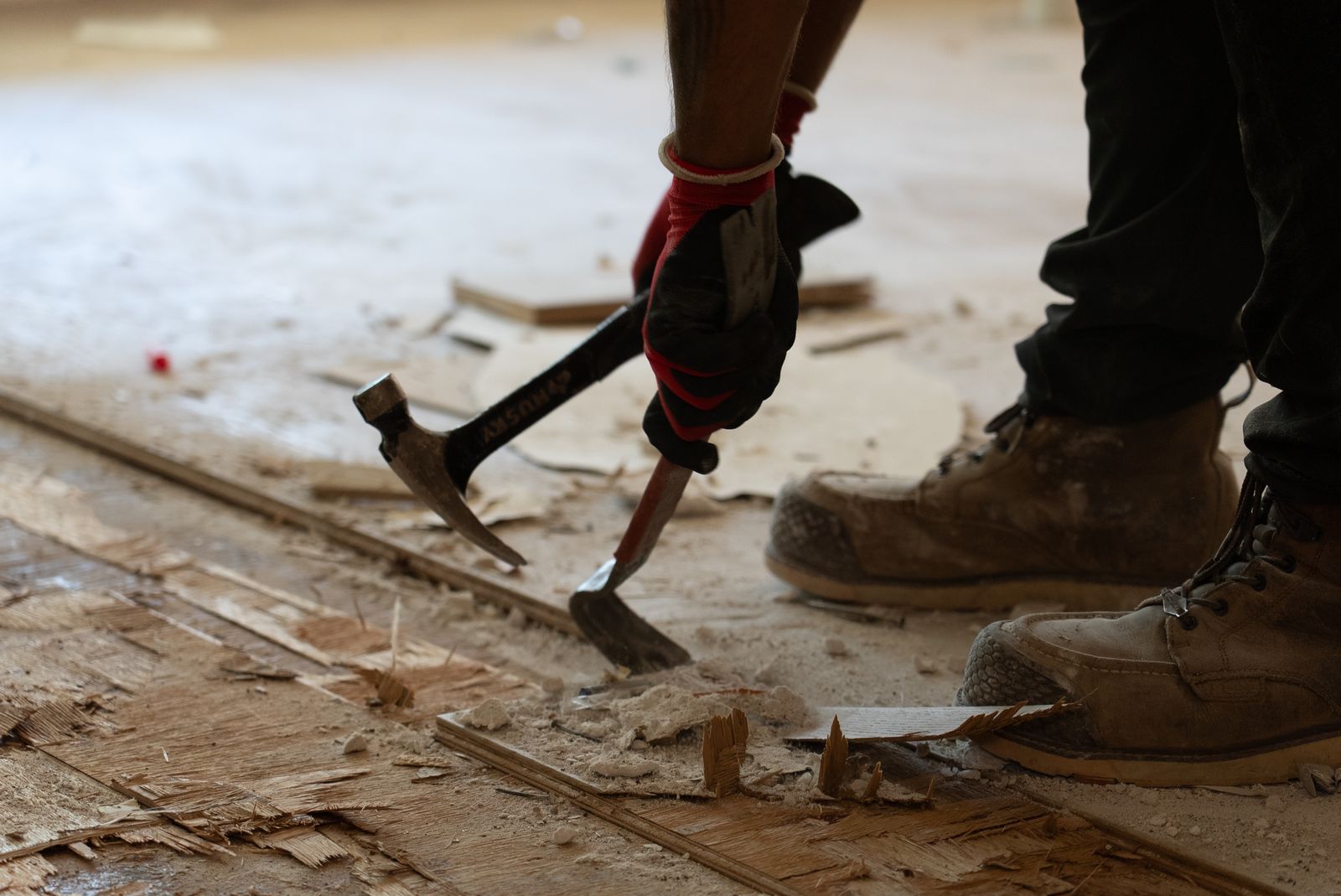 Floor demolition detail — hammer and pry bar